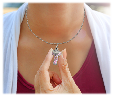woman wearing teardrop cremation necklace and holding pendant between fingers